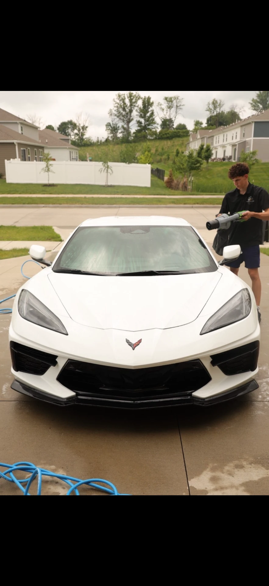 Jake, owner of Street Standard Detailing, hand-drying a Chevrolet Corvette C8